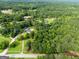 Aerial view of wooded neighborhood with houses and long driveways between plots of land at 396 Ebenezer Rd, Fayetteville, GA 30215
