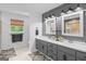 Modern bathroom featuring double vanity, wood accent wall, and ample natural light at 396 Ebenezer Rd, Fayetteville, GA 30215