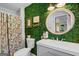 Unique bathroom featuring a modern vanity, round mirror, and green wall covering at 396 Ebenezer Rd, Fayetteville, GA 30215