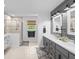 Bright bathroom featuring double vanity, walk-in shower and neutral tile flooring at 396 Ebenezer Rd, Fayetteville, GA 30215