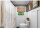 Charming bathroom with board and batten, decorative floral shower curtain, and a window at 396 Ebenezer Rd, Fayetteville, GA 30215