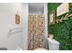 Unique bathroom featuring a modern vanity, round mirror, and green wall covering at 396 Ebenezer Rd, Fayetteville, GA 30215