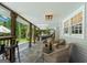 Inviting covered patio with stone flooring, comfortable seating, bar area, and backyard views at 396 Ebenezer Rd, Fayetteville, GA 30215