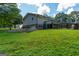 Exterior side view of a home showcasing a deck, walkout basement, and a well-maintained lawn at 396 Ebenezer Rd, Fayetteville, GA 30215