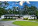 Charming front exterior of the home with beautiful landscaping and a winding driveway at 396 Ebenezer Rd, Fayetteville, GA 30215