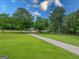 Spacious front yard with a long driveway and an established tree line at 396 Ebenezer Rd, Fayetteville, GA 30215