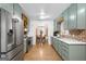 Bright kitchen boasts stainless steel appliances, unique green cabinets and hardwood floors at 396 Ebenezer Rd, Fayetteville, GA 30215