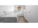 Well-lit laundry room with white walls, wood-look flooring, and a window for natural light at 396 Ebenezer Rd, Fayetteville, GA 30215