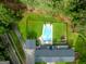Aerial shot of the in-ground pool with chairs, diving board, and well-manicured lawn at 396 Ebenezer Rd, Fayetteville, GA 30215