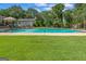 Inviting in-ground pool with a diving board, steps and lush green surrounding lawn at 396 Ebenezer Rd, Fayetteville, GA 30215