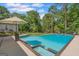 Swimming pool with sun umbrella, steps and lush green surroundings at 396 Ebenezer Rd, Fayetteville, GA 30215