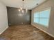 Elegant dining room with modern chandelier, sleek wall paneling, and bright natural light, perfect for entertaining at 248 Webster Lake Dr, Temple, GA 30179