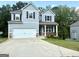 Inviting two-story home with a two-car garage and driveway, set against a backdrop of lush greenery at 248 Webster Lake Dr, Temple, GA 30179