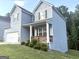 Charming two-story home showcasing a welcoming front porch, attached garage, and a well-maintained lawn with tasteful landscaping at 248 Webster Lake Dr, Temple, GA 30179