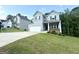 Well-maintained two-story home featuring a two-car garage and a sloping front yard with lush green grass at 248 Webster Lake Dr, Temple, GA 30179