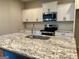 Beautiful kitchen island with granite countertops, stainless steel sink, and stylish faucet, a chef's dream at 248 Webster Lake Dr, Temple, GA 30179