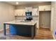 Modern kitchen with white cabinets, stainless steel appliances, and a large center island with granite countertops at 248 Webster Lake Dr, Temple, GA 30179
