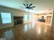 Spacious living area features a cozy stone fireplace, hardwood floors, and an open floor plan to the kitchen at 248 Webster Lake Dr, Temple, GA 30179