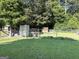 Backyard with secure fencing, small sheds, and ample green space, ideal for pets or outdoor activities at 4790 Hwy 101 N, Rockmart, GA 30153