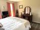 Spacious bedroom featuring hardwood floors, a dark wooden vanity, and pink curtains at 4790 Hwy 101 N, Rockmart, GA 30153