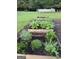 Outdoor garden featuring raised beds with vegetables, herbs, and decorative plants in a backyard setting at 4790 Hwy 101 N, Rockmart, GA 30153