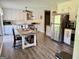 Bright kitchen with white cabinets, stainless steel appliances, and a rustic dining table at 4790 Hwy 101 N, Rockmart, GA 30153