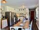 Functional kitchen featuring stainless steel appliances, white cabinetry, and a wooden dining table at 4790 Hwy 101 N, Rockmart, GA 30153