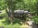 Aerial view of a cozy house nestled among lush trees with a long driveway at 4352 Treeline Way, Douglasville, GA 30135
