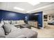 Basement media room features a large sectional sofa and a large TV at 4352 Treeline Way, Douglasville, GA 30135