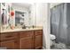 Bathroom featuring wood cabinets, a grey shower curtain, and neutral walls at 4352 Treeline Way, Douglasville, GA 30135