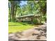 Charming home with a large front yard, mature trees, and a welcoming front porch at 4352 Treeline Way, Douglasville, GA 30135