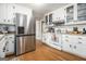 Modern kitchen featuring stainless steel appliances, white cabinetry and wood flooring at 4352 Treeline Way, Douglasville, GA 30135
