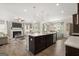 Open-concept kitchen with large island, stainless steel appliances, and adjacent living area at 10422 Trellis Lane (Lot 38), Hampton, GA 30228