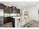 Elegant kitchen with white countertop island, pendant lighting, and dark cabinets at 10422 Trellis Lane (Lot 38), Hampton, GA 30228