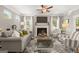 Comfortable living room with a fireplace, ceiling fan, and abundant natural light at 10422 Trellis Lane (Lot 38), Hampton, GA 30228