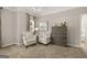 A serene main bedroom features a tray ceiling, soft carpet, and elegant decor and furnishings at 10422 Trellis Lane (Lot 38), Hampton, GA 30228