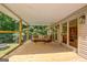 Inviting screened porch with comfortable seating, coffee table, and views of the surrounding greenery at 351 Weldon Rd, Palmetto, GA 30268