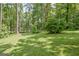 Lush green lawn with mature trees, perfect for outdoor activities at 351 Weldon Rd, Palmetto, GA 30268