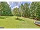 The huge backyard offers mature trees, a tree swing, storage shed and other recreation at 351 Weldon Rd, Palmetto, GA 30268