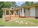 Home's backyard featuring an expansive deck, lush green lawn, mature trees, and well-maintained landscaping at 351 Weldon Rd, Palmetto, GA 30268