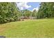 Expansive backyard featuring a spacious lawn and wooded perimeter, perfect for outdoor activities and privacy at 351 Weldon Rd, Palmetto, GA 30268