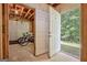 View into unfinished basement with exposed rafters, two bicycles and a pair of white doors to the outside at 351 Weldon Rd, Palmetto, GA 30268