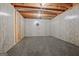 Partially finished basement area with carpet, paneled walls, and open ceiling, perfect for a recreation room at 351 Weldon Rd, Palmetto, GA 30268