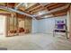 Unfinished basement with open ceiling, concrete floor, and basketball hoop for potential recreation or storage at 351 Weldon Rd, Palmetto, GA 30268