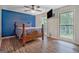 Bright bedroom showcasing a large window with lots of natural light and blue accent wall at 351 Weldon Rd, Palmetto, GA 30268