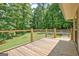 Relax on this wood deck with metal railing with expansive view of the surrounding lawn at 351 Weldon Rd, Palmetto, GA 30268