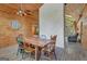 This dining room features a stone accent wall, rustic dining set, and wood paneled ceiling at 351 Weldon Rd, Palmetto, GA 30268