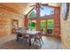 Enjoy meals in this dining room featuring wood paneling, large windows, and rustic wood table at 351 Weldon Rd, Palmetto, GA 30268