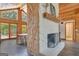 Close up of the stone fireplace between dining room and living room with wood paneled walls at 351 Weldon Rd, Palmetto, GA 30268