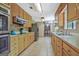 Spacious kitchen with light wood cabinets, stainless steel appliances, and tile flooring at 351 Weldon Rd, Palmetto, GA 30268
